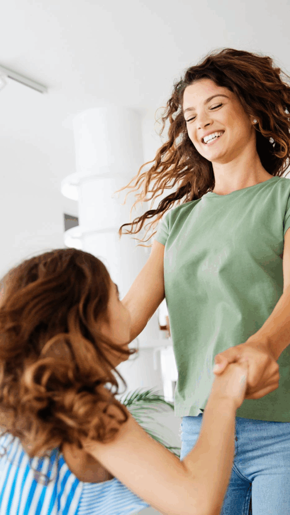 Mother and daughter playing joyfully at home — building connection through shared moments.
